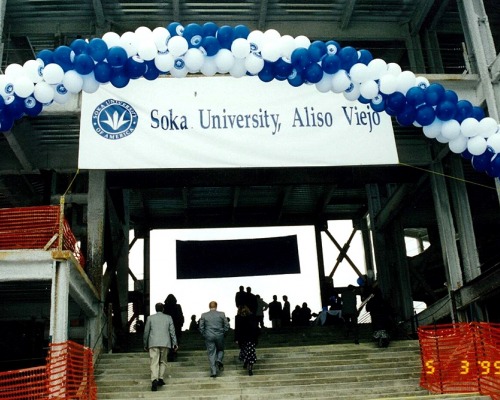 People walk up steps to Ikeda Library entrance