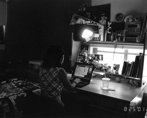 Student working at laptop in residence hall room