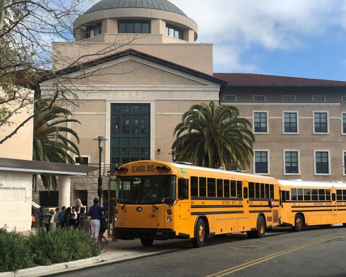 School buses line up outside Founders Hall
