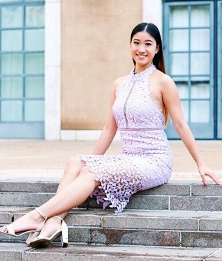 Student in lilac dress smiling at camera