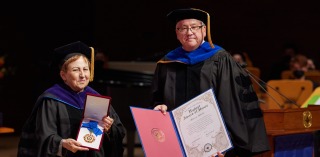President Ed Feasel and 2022 Commencement Speaker Shirin Ebadi pose with the awards