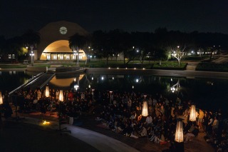 A large gathering of students hold vigil for Lucas during an evening ceremony in front of Peace Lake.