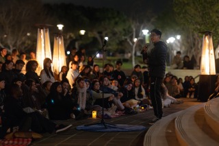 Jun Sawada '26 speaks to the crowd during Lucas' vigil.